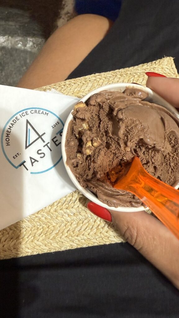 A cup of chocolate gelato next to a 4 Tastes napkin
