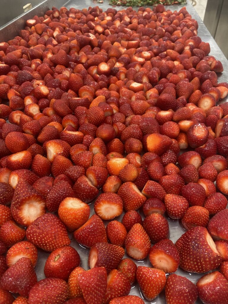 Fresh strawberries, hulled and cut in the 4 Tastes workshop